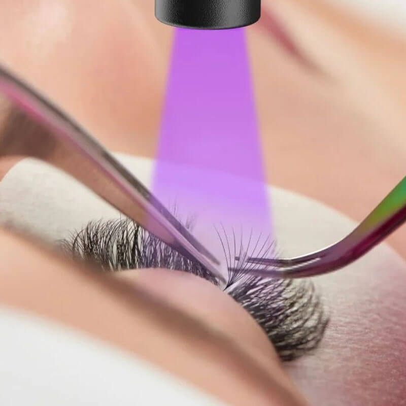 UV lash extension with UV light, applying lash glue, professional eyelash extensions.