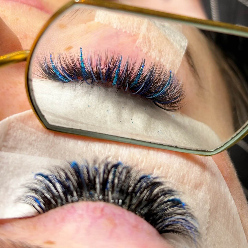 Blue Glitter Eyelash Extensions on a client, showing C curl 0.07mm thickness. Perfect for highlighting and adding sparkle.