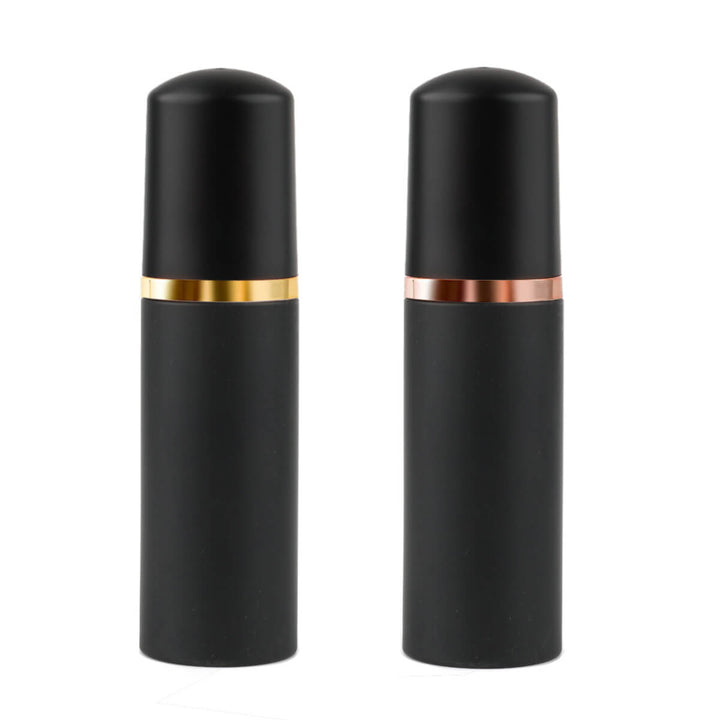 Eyelash extension cleanser foam bottles in black with gold and rose gold accents