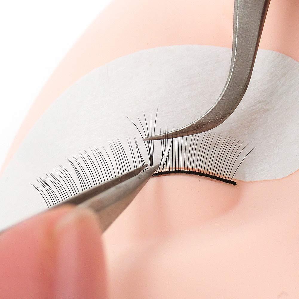 Eyelash extension application on mannequin head with tweezers