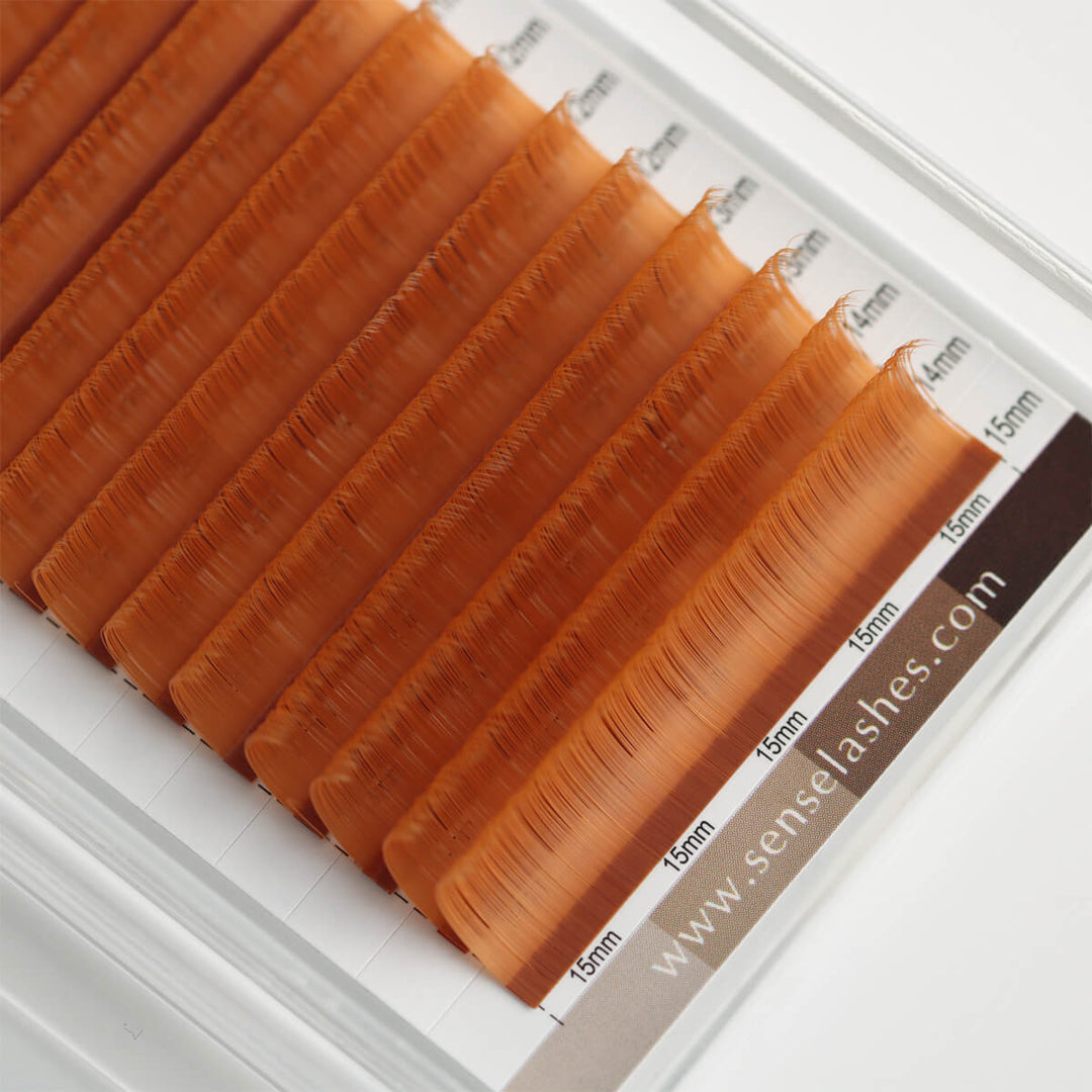 Amber Soft Cinnamon Matte Brown Lashes, individually boxed in a tray labeled with 15mm and 14mm.