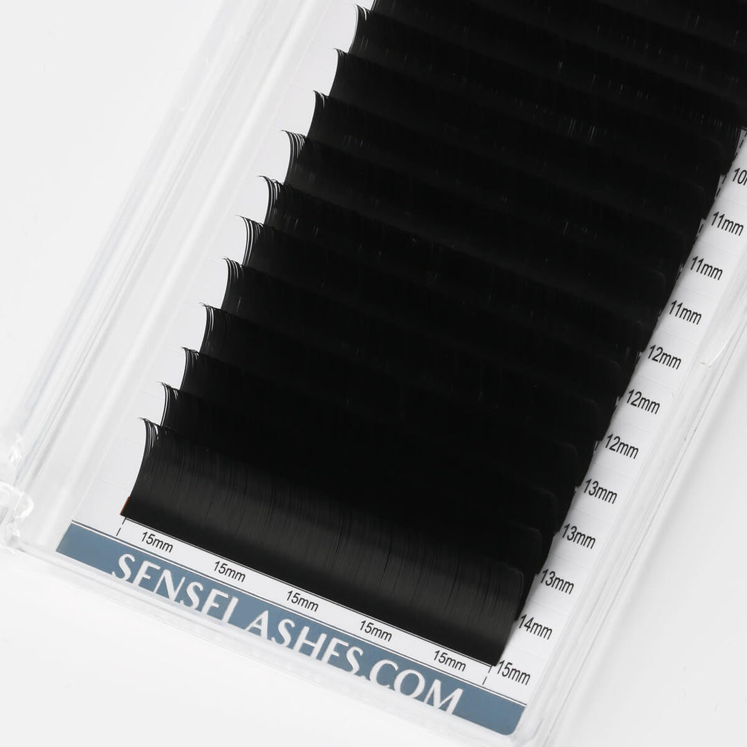 SENSELASHES.COM professional black lash extensions in a tray, featuring lengths from 11mm to 15mm for diverse styles.