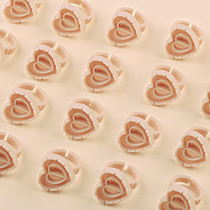 Beige heart-shaped lash glue rings for eyelash extension fans, 100pcs pack