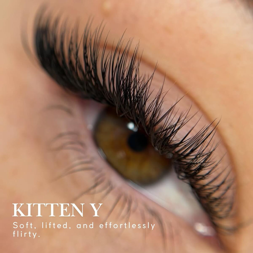 Close-up of a brown eye with applied Kitten YY lashes, featuring a lifted, flirty cat-eye effect.