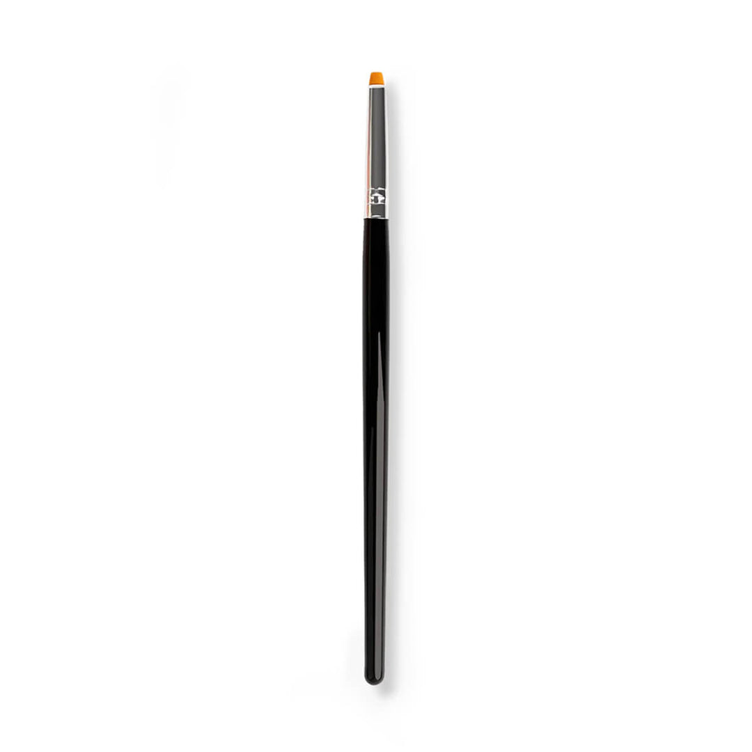 Lash lift balm brush applying balm to lifted eyelashes for even lash coating