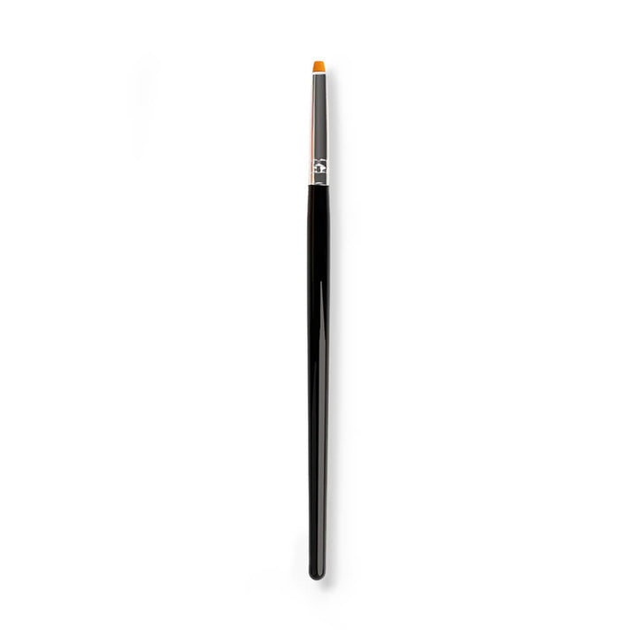 Lash lift balm brush applying balm to lifted eyelashes for even lash coating