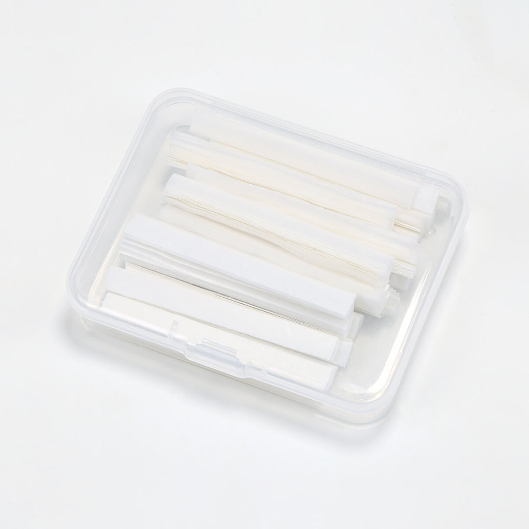 Clear plastic box of white lash lift paper compensator strips