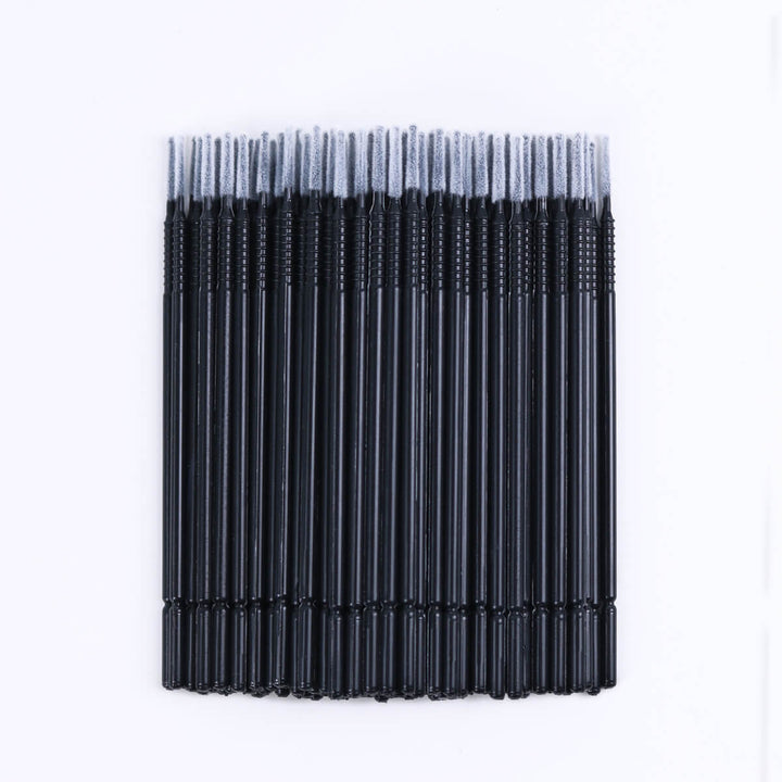 Micro brush swabs for eyelash extensions, clear tube, black base. Lash primer and remover applicator.