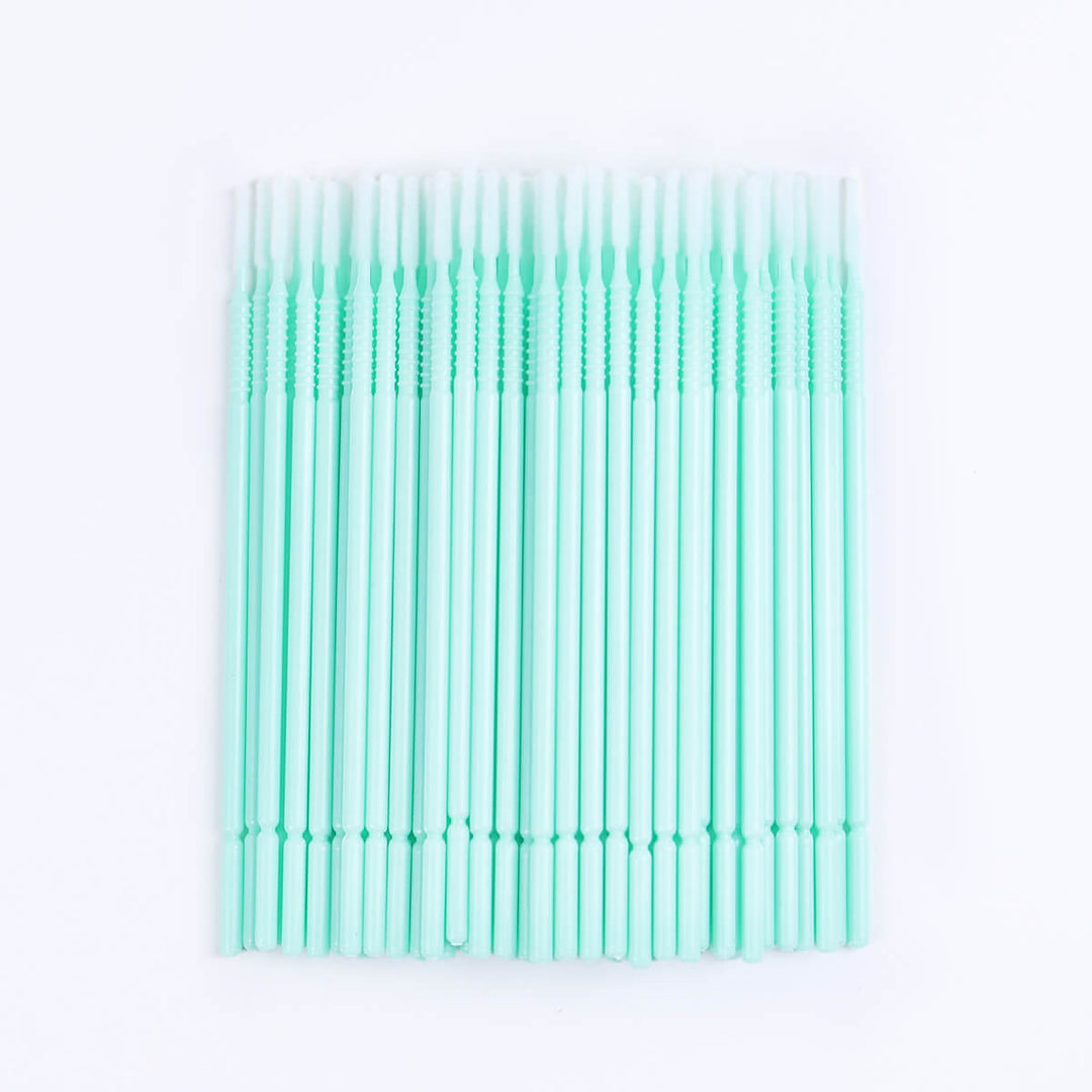 Micro brush swabs for eyelash extensions, clear tube, blue base. Lash primer and remover applicator.
