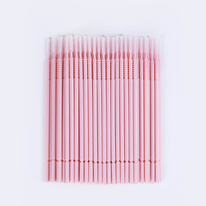 Micro brush swabs for eyelash extensions, clear tube, pink base. Lash primer and remover applicator.