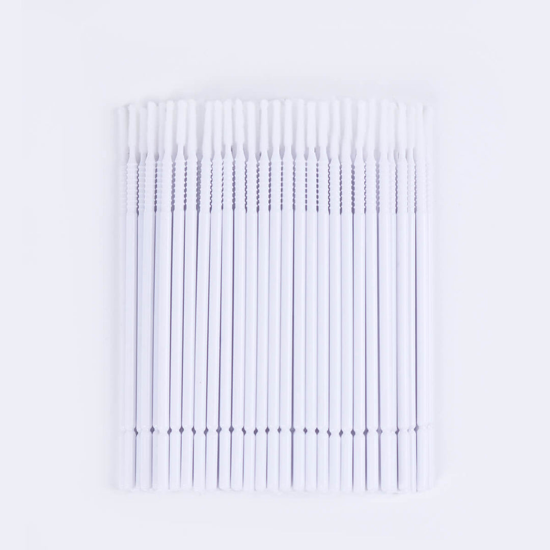 Micro brush swabs for eyelash extensions, applicator with white handle, white tip and clear container.