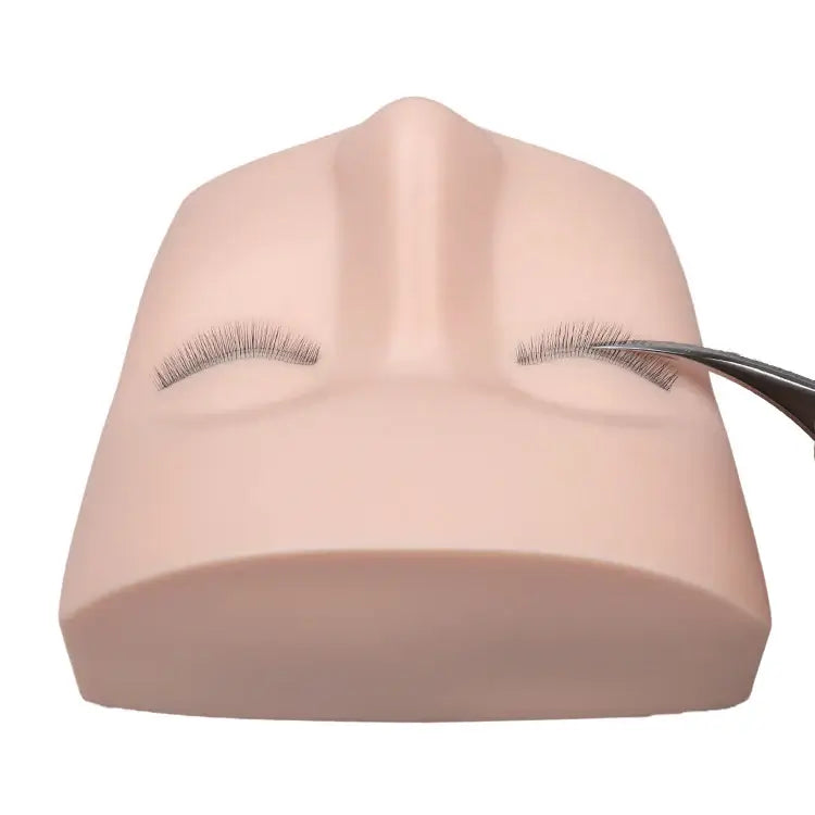 Eyelash extension practice on a mannequin head, silicone material, with tweezers
