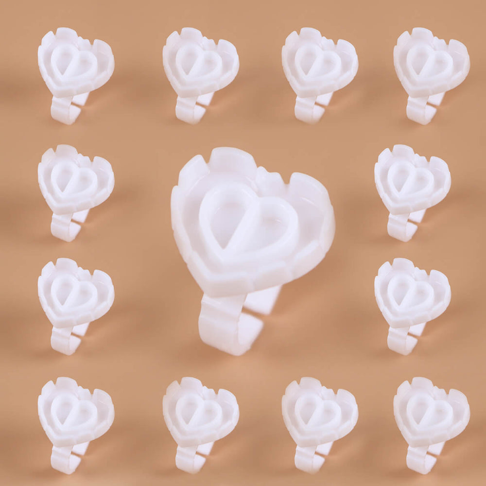 Sweet Heart Glue Cups, white heart-shaped clips arranged neatly on a beige background.
