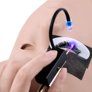Touch-controlled UV tweezer lamp curing eyelash extension glue on training mannequin