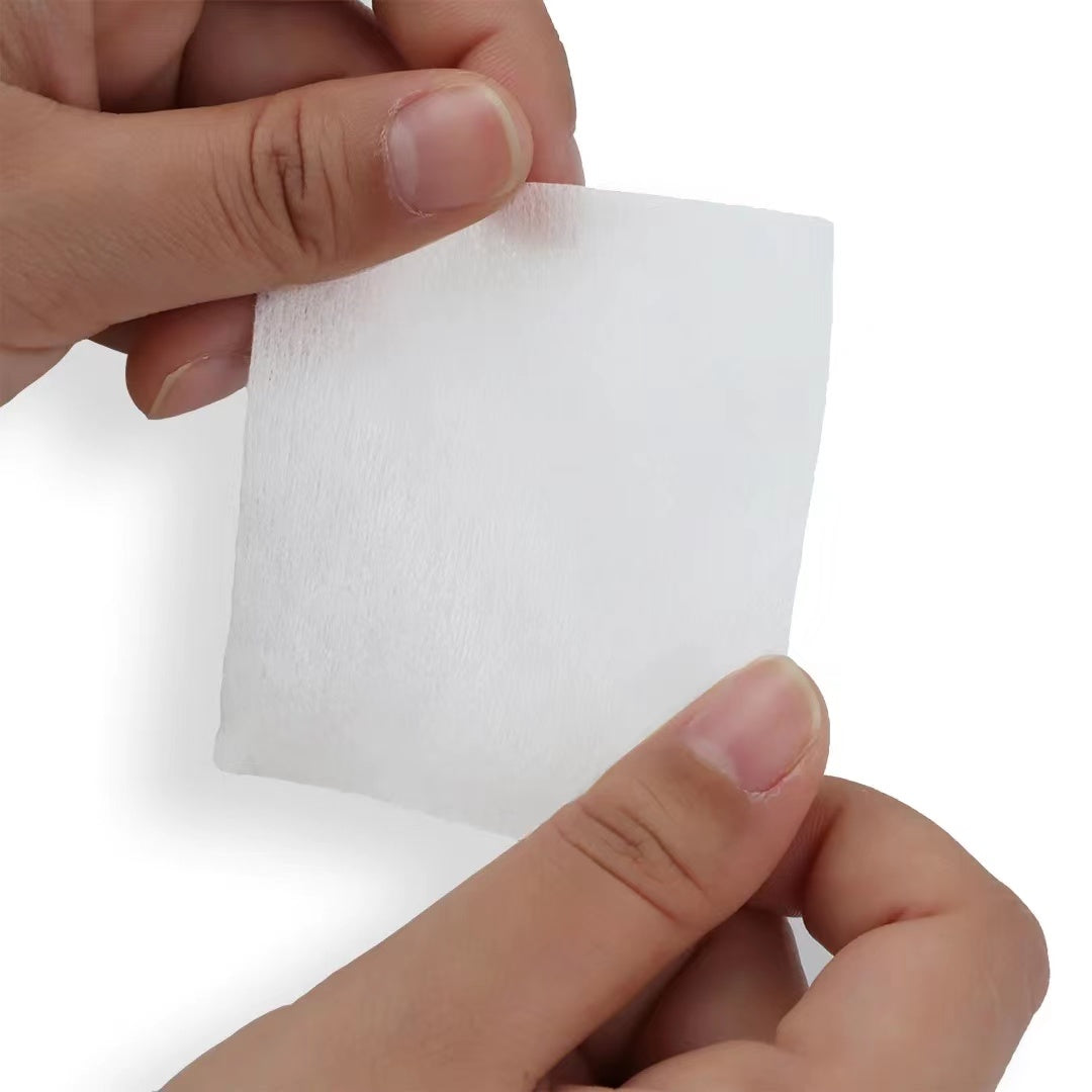 100% cotton disposable face towel held 