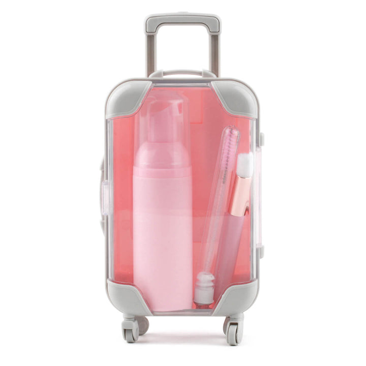Pink eyelash aftercare kit in a travel suitcase 